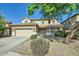 Charming two-story home featuring a two-car garage, stone accents, and a well-manicured front yard under a blue sky at 29828 N 72Nd Ln, Peoria, AZ 85383