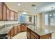 Kitchen featuring wood cabinets, granite countertops, a breakfast bar, and stainless steel appliances at 29828 N 72Nd Ln, Peoria, AZ 85383