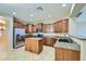 Kitchen featuring wood cabinets, granite countertops, stainless steel appliances, and a center island at 29828 N 72Nd Ln, Peoria, AZ 85383