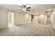 Spacious loft area with plush carpeting, neutral paint, and modern ceiling fan at 29828 N 72Nd Ln, Peoria, AZ 85383