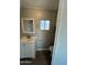 A well-lit bathroom with a classic white vanity, a framed mirror, and essential fixtures at 300 S Val Vista Dr # 17, Mesa, AZ 85204