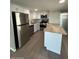 Well-equipped kitchen featuring stainless steel appliances, white cabinetry and a granite countertop island at 300 S Val Vista Dr # 17, Mesa, AZ 85204
