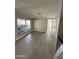 Bright living room featuring new flooring and natural light from multiple windows at 300 S Val Vista Dr # 17, Mesa, AZ 85204