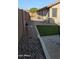 View of the landscaped backyard with artificial turf, walkway, and tiki torches at 31138 N 130Th Ln, Peoria, AZ 85383