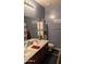This bathroom features a double vanity, large mirror, and storage cabinet for organization at 31138 N 130Th Ln, Peoria, AZ 85383