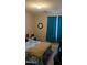 Bedroom featuring natural light from a window with blue curtains plus bed with blue comforter at 31138 N 130Th Ln, Peoria, AZ 85383