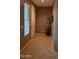 Welcoming entryway with tile flooring, a decorative baker's rack, and natural light from a window at 31138 N 130Th Ln, Peoria, AZ 85383