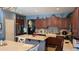 Bright kitchen with granite countertops, wooden cabinetry, and a farmhouse sink at 31138 N 130Th Ln, Peoria, AZ 85383