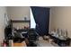 Office space with desk, office chair, and dark curtains, offering a productive work environment at 31138 N 130Th Ln, Peoria, AZ 85383
