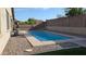 Backyard pool surrounded by desert landscaping and featuring an outdoor cooking area at 31138 N 130Th Ln, Peoria, AZ 85383