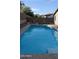Wide angle showcases the pool with cool, clear water, and tidy backyard landscaping at 31138 N 130Th Ln, Peoria, AZ 85383