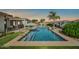 Serene backyard oasis with a sparkling pool, mature landscaping, and a peaceful setting for outdoor enjoyment at 3125 W Desert Ln, Laveen, AZ 85339