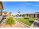 Beautiful backyard with a refreshing pool, covered patio, lush artificial turf, and scenic mountain views at 3125 W Desert Ln, Laveen, AZ 85339