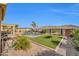 Beautiful backyard oasis featuring a pool, landscaped turf, and a serene seating area at 3125 W Desert Ln, Laveen, AZ 85339