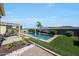 Landscaped backyard with in-ground pool, manicured artificial grass, and patio at 3125 W Desert Ln, Laveen, AZ 85339