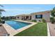 Outdoor oasis with a pool, and artificial turf, perfect for relaxation at 3125 W Desert Ln, Laveen, AZ 85339