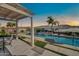 Inviting outdoor space with a covered patio and sparkling pool, perfect for relaxing and enjoying the Arizona sunshine at 3125 W Desert Ln, Laveen, AZ 85339