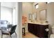 Bathroom boasts double vanities, square mirrors, tile floors and view of a bedroom at 3125 W Desert Ln, Laveen, AZ 85339