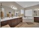 Bright primary bathroom featuring dual sinks, a soaking tub, and large mirrors at 3125 W Desert Ln, Laveen, AZ 85339