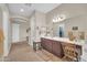 A bathroom boasts tile flooring, a spacious vanity with a chair, and an arched entrance leading to other rooms at 3125 W Desert Ln, Laveen, AZ 85339