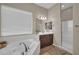 Bathroom featuring a soaking tub, walk-in shower, double vanity, and neutral tones for a spa-like retreat at 3125 W Desert Ln, Laveen, AZ 85339