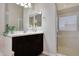 Bright bathroom with a glass shower, dark wood cabinets, and a double mirror at 3125 W Desert Ln, Laveen, AZ 85339