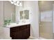 Bathroom features a large mirror over a dark wood vanity, complemented by a walk-in shower at 3125 W Desert Ln, Laveen, AZ 85339