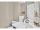 A bathroom has a single sink, a mirror, and a toilet, reflecting a practical and clean design at 3125 W Desert Ln, Laveen, AZ 85339