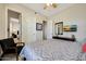 Cozy bedroom with a patterned bedspread, a TV, and an adjoining room view at 3125 W Desert Ln, Laveen, AZ 85339