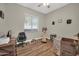 Bright, versatile bedroom space with wood floors, a fan, and ample natural light at 3125 W Desert Ln, Laveen, AZ 85339