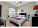 Tranquil bedroom with a large window, ceiling fan, and neutral decor at 3125 W Desert Ln, Laveen, AZ 85339