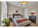 Comfortable bedroom with warm lighting, a ceiling fan, and soft, neutral colors at 3125 W Desert Ln, Laveen, AZ 85339