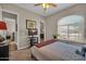 Cozy bedroom featuring a ceiling fan, plush carpet, and a bright window at 3125 W Desert Ln, Laveen, AZ 85339