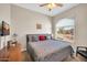 Serene bedroom features a large window with neighborhood views, warm lighting, and neutral tones at 3125 W Desert Ln, Laveen, AZ 85339
