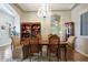 Formal dining room with chandelier, wood floors, and traditional dining furniture at 3125 W Desert Ln, Laveen, AZ 85339