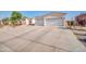 Spacious driveway leading to a three-car garage, highlighting the home's ample parking and curb appeal at 3125 W Desert Ln, Laveen, AZ 85339