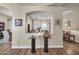 Inviting entryway with sleek wood flooring, decorative glass table, and views into an elegant living area at 3125 W Desert Ln, Laveen, AZ 85339
