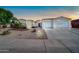 Charming single-story home boasting a three-car garage, desert landscaping, and a welcoming front entrance at 3125 W Desert Ln, Laveen, AZ 85339