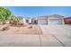 Inviting single-story home featuring a three car garage, desert landscaping, and a beautiful stucco exterior at 3125 W Desert Ln, Laveen, AZ 85339