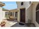 Close-up of front entrance with decorative door, desert landscaping and wrought iron seating at 3125 W Desert Ln, Laveen, AZ 85339