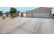 Inviting single-story home with a spacious driveway and two-car garage, surrounded by desert landscaping at 3125 W Desert Ln, Laveen, AZ 85339
