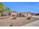 Charming home with a desert landscape, manicured greenery, and an attached three car garage at 3125 W Desert Ln, Laveen, AZ 85339