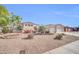 Well-maintained desert front yard displaying drought-resistant landscaping, including gravel, cacti and colorful flowering plants at 3125 W Desert Ln, Laveen, AZ 85339