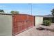 Gated entrance to a property with desert landscaping, offering privacy and security at 3125 W Desert Ln, Laveen, AZ 85339
