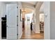 Hallway view with hardwood floors, elegant lighting, and stylish decor leading to various rooms at 3125 W Desert Ln, Laveen, AZ 85339