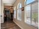 Bright hallway with wood floors, arched windows with blinds, and neutral paint at 3125 W Desert Ln, Laveen, AZ 85339