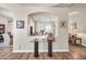 Stylish hallway featuring wood floors and a glass-topped table, providing a glimpse into adjacent rooms at 3125 W Desert Ln, Laveen, AZ 85339