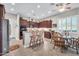 Bright kitchen featuring dark wood cabinets, stainless appliances, and breakfast area at 3125 W Desert Ln, Laveen, AZ 85339