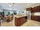 Open kitchen and dining area with stainless steel fridge, breakfast bar, and tile flooring at 3125 W Desert Ln, Laveen, AZ 85339