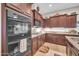 Well-equipped kitchen with granite countertops, gas cooktop, and tile flooring at 3125 W Desert Ln, Laveen, AZ 85339